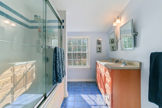 bathroom with tile patterned flooring, vanity, a shower with door, and vaulted ceiling