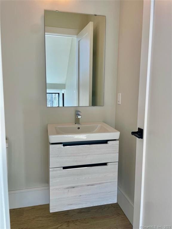 bathroom with vanity and wood-type flooring