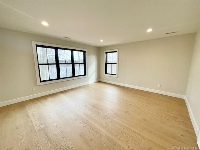 unfurnished room with light wood-type flooring