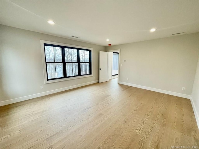 spare room featuring light hardwood / wood-style floors