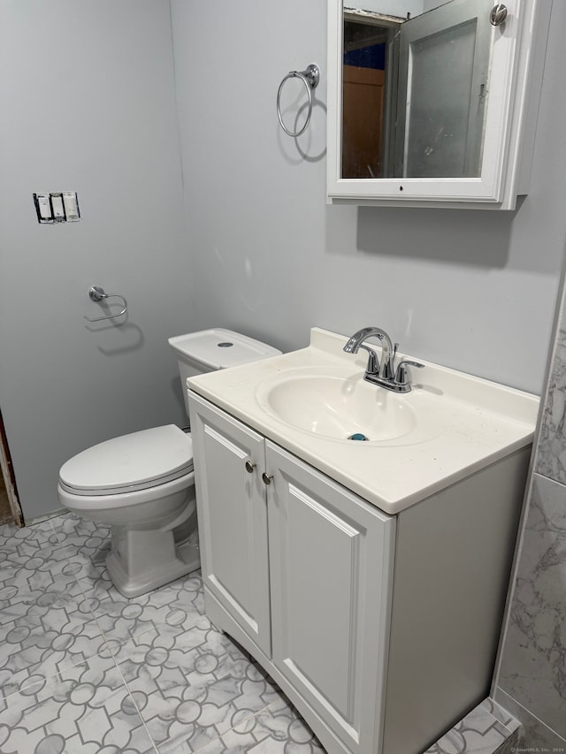 bathroom with toilet and vanity