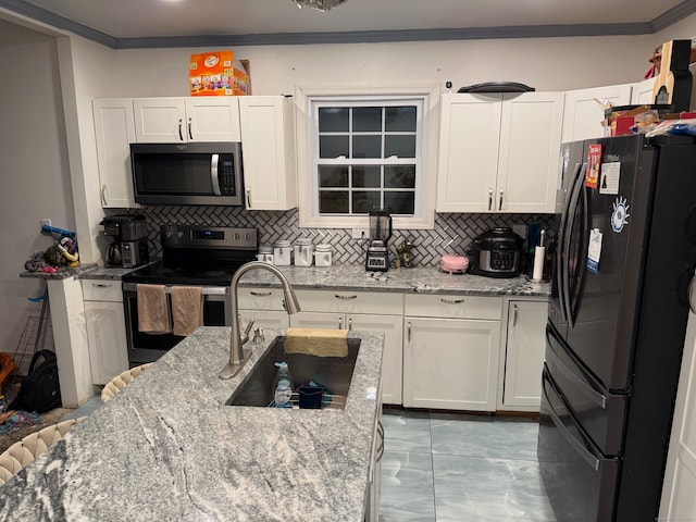 kitchen with stainless steel appliances, white cabinets, light stone counters, and tasteful backsplash