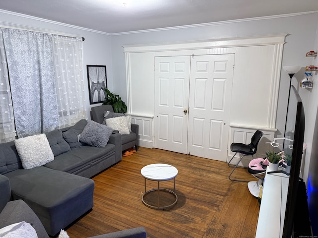 living room with hardwood / wood-style floors and crown molding