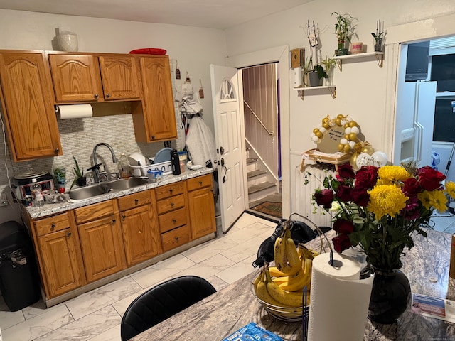 kitchen with decorative backsplash and sink