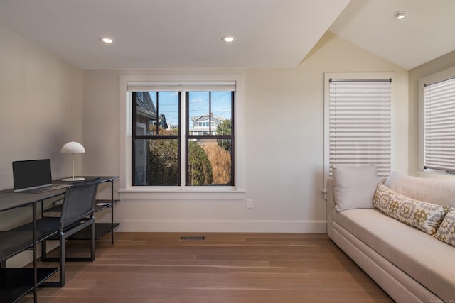 office with hardwood / wood-style floors and lofted ceiling