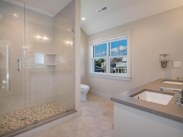 bathroom with toilet, walk in shower, lofted ceiling, tile patterned floors, and vanity