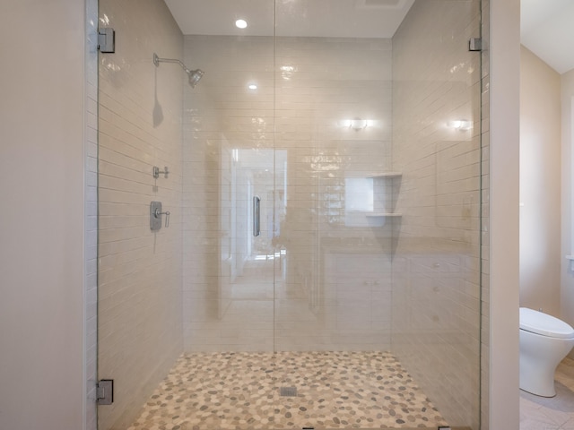 bathroom with walk in shower and toilet