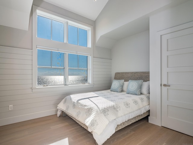 bedroom featuring lofted ceiling and wood-type flooring