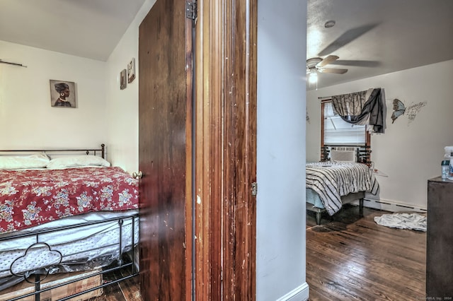 bedroom with ceiling fan, cooling unit, wood-type flooring, and baseboard heating