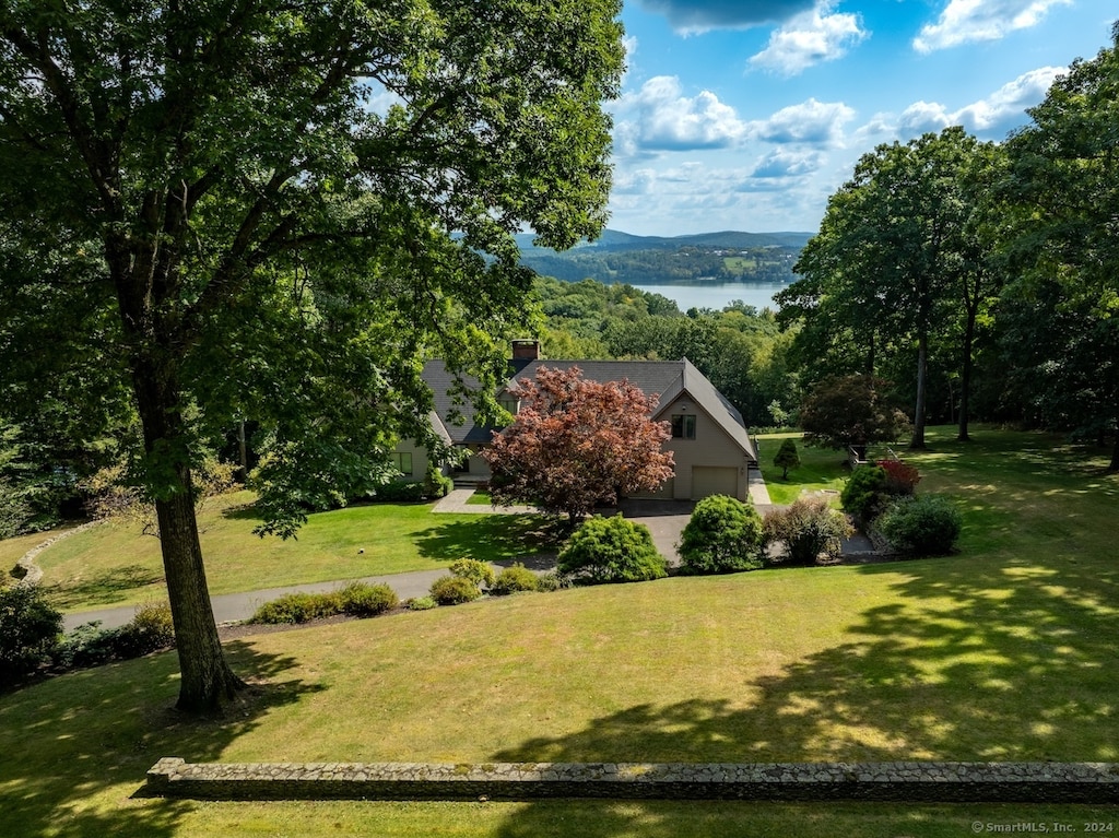 view of yard featuring a garage and a water view