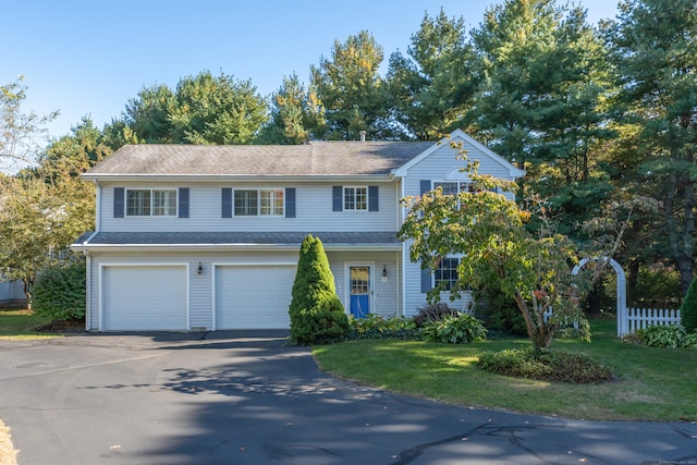 view of front of house with a garage and a front yard