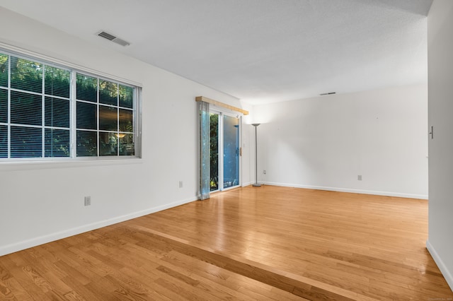 unfurnished room with light hardwood / wood-style flooring