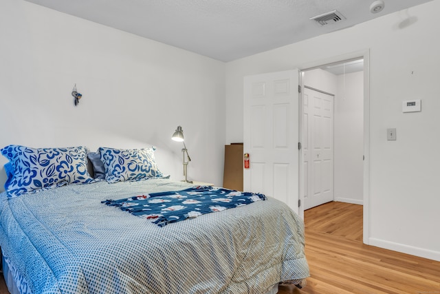 bedroom with a closet and wood-type flooring