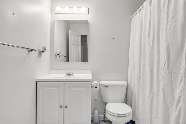 bathroom featuring walk in shower, vanity, and toilet