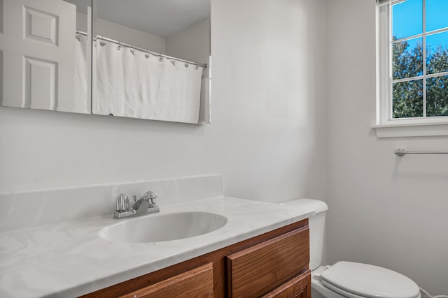 bathroom featuring toilet and vanity