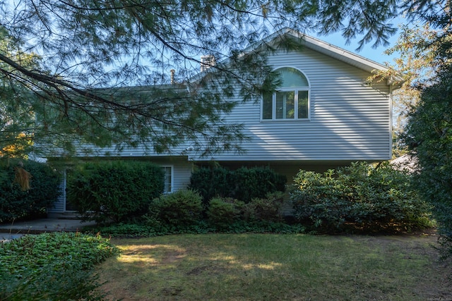 view of side of home featuring a lawn