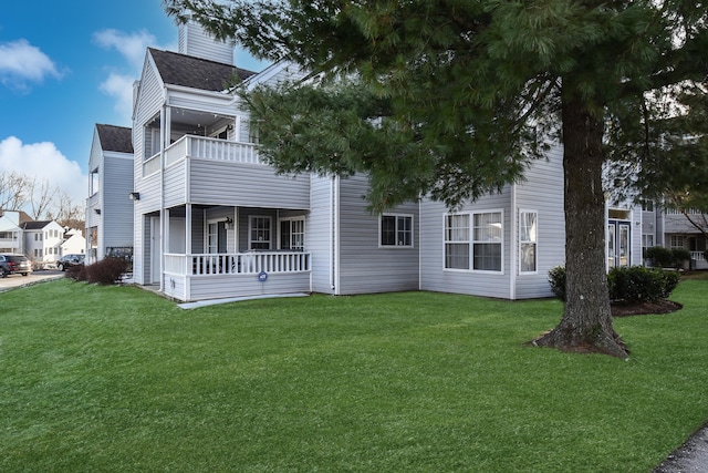 exterior space with a lawn, a balcony, and covered porch