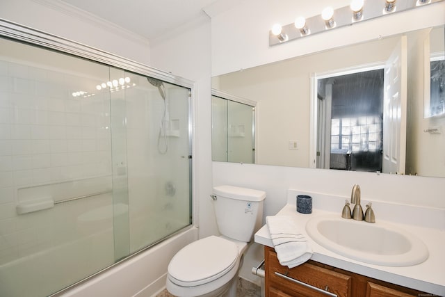 full bathroom featuring vanity, toilet, crown molding, and bath / shower combo with glass door