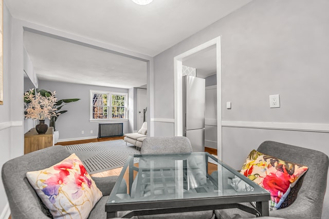 living room with wood-type flooring and radiator