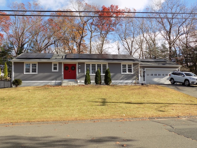 single story home with a garage and a front lawn