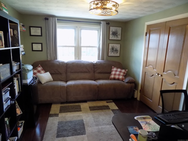 living room featuring dark hardwood / wood-style floors and a textured ceiling