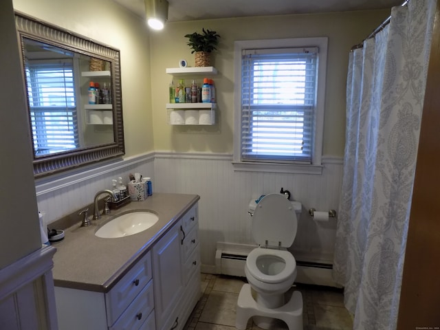 bathroom with vanity, tile patterned flooring, toilet, and a baseboard heating unit