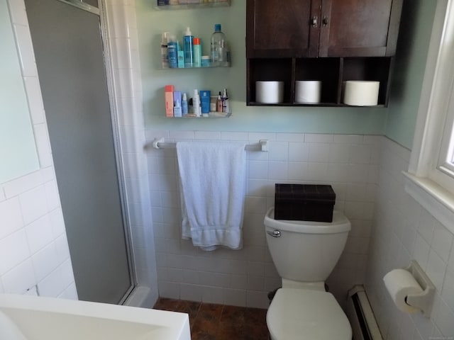 bathroom featuring tile walls, a baseboard radiator, toilet, and a shower with door