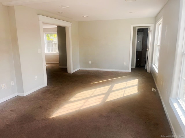 empty room with dark carpet