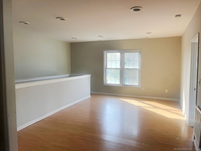 spare room featuring light wood-type flooring