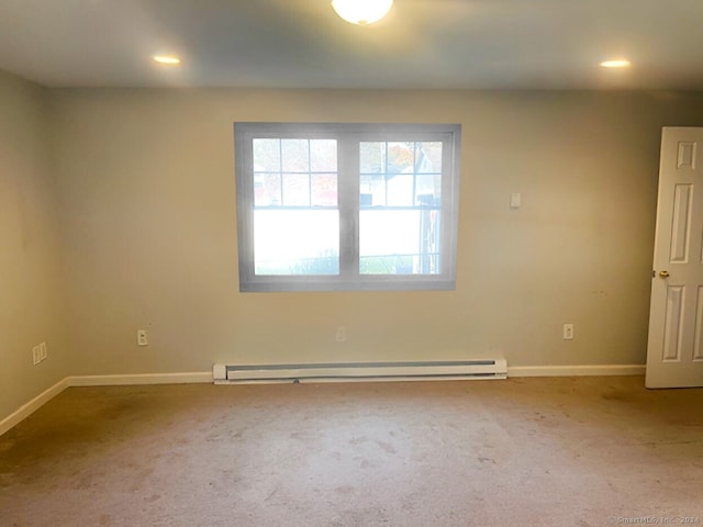 empty room with carpet floors and baseboard heating