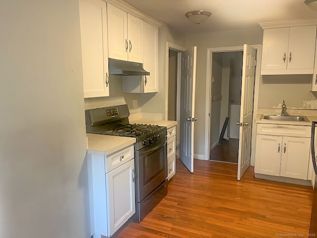 kitchen featuring white cabinetry, black gas stove, and light wood-type flooring