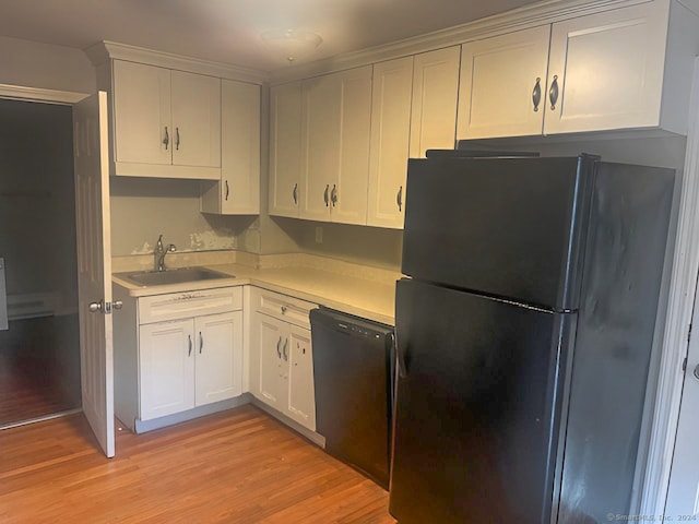 kitchen with black appliances, light wood-type flooring, white cabinetry, and sink