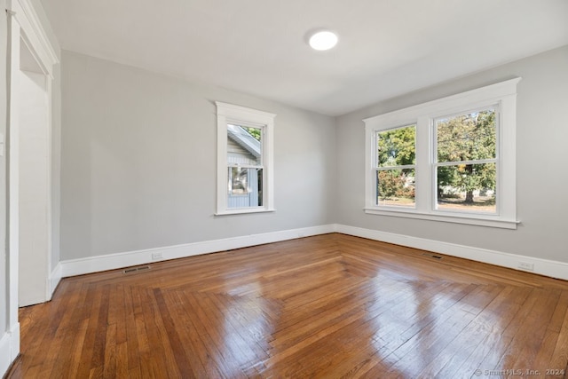 empty room with hardwood / wood-style flooring