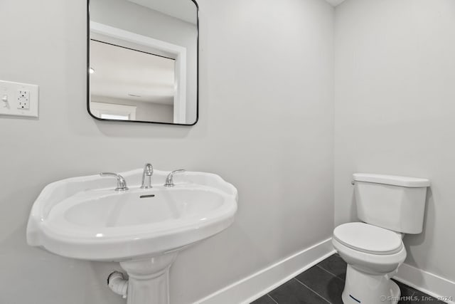 bathroom with sink, tile patterned flooring, and toilet