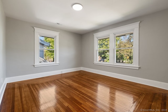 unfurnished room featuring hardwood / wood-style flooring