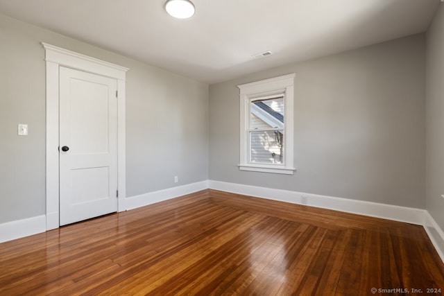 spare room with wood-type flooring