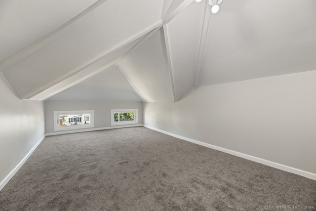 bonus room with carpet flooring and vaulted ceiling