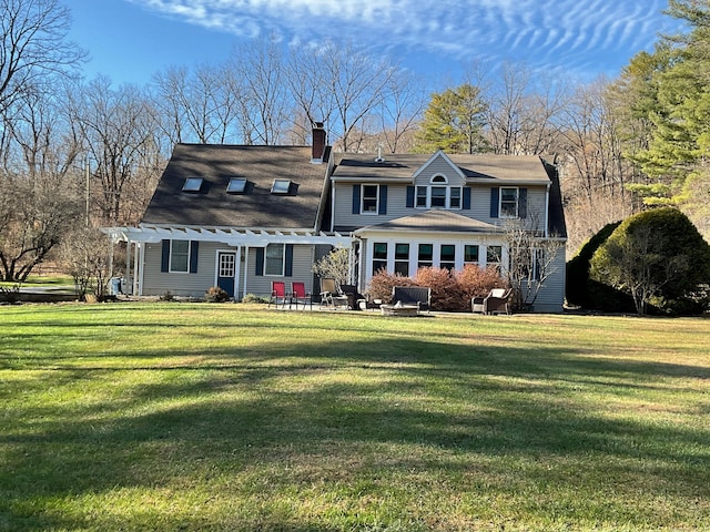 rear view of house with a yard, a pergola, and a patio area