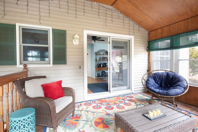 sunroom with ceiling fan, wood ceiling, and vaulted ceiling