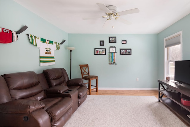 living room featuring wood-type flooring and ceiling fan