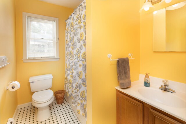 bathroom featuring a shower with curtain, vanity, baseboard heating, tile patterned flooring, and toilet