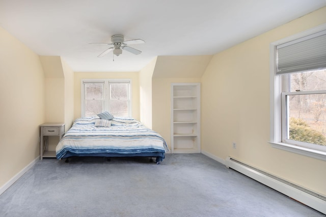 bedroom with carpet floors, vaulted ceiling, baseboard heating, and ceiling fan