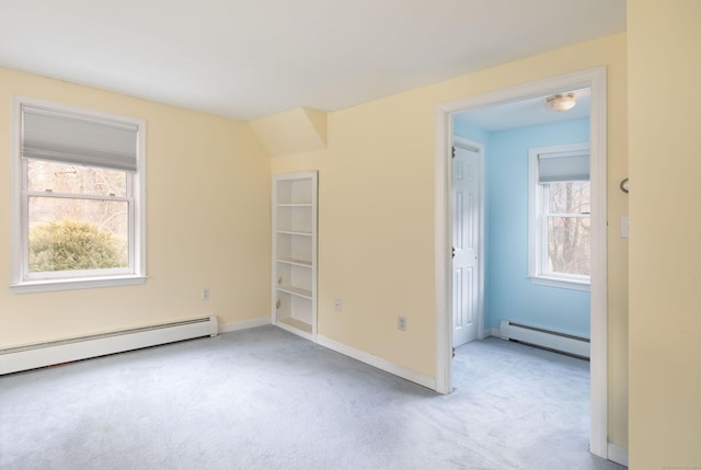 spare room featuring light carpet and baseboard heating