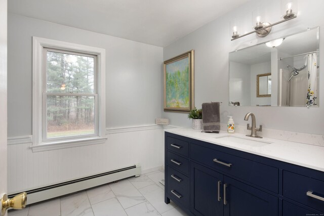 bathroom featuring vanity, curtained shower, baseboard heating, and a wealth of natural light