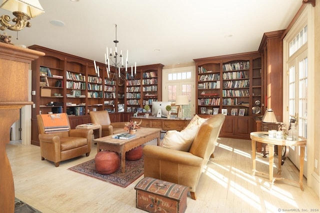 10 N Beaver Dam Rd, Salisbury, CT 06068 - sitting room with a chandelier, wood finished floors, and bookshelves
