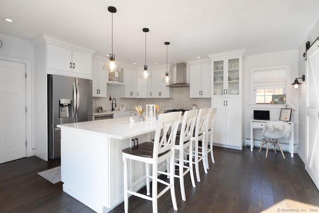 10 N Beaver Dam Rd, Salisbury, CT 06068 - kitchen featuring stainless steel fridge with ice dispenser, wall chimney exhaust hood, white cabinets, a barn door, and dark wood-style floors
