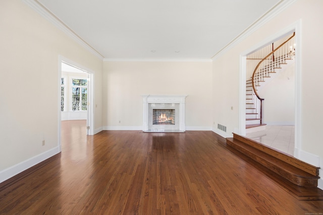 unfurnished living room with crown molding and hardwood / wood-style floors