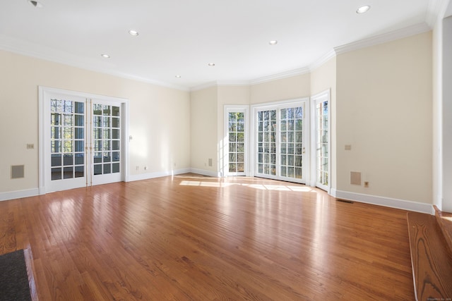 spare room with french doors, light hardwood / wood-style flooring, and crown molding