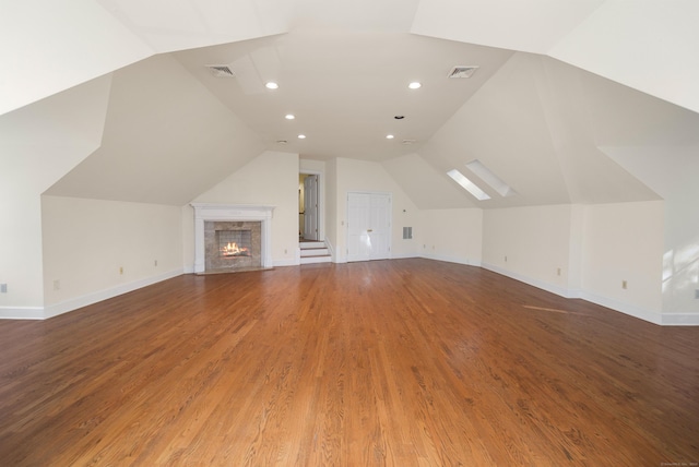 bonus room with hardwood / wood-style floors and vaulted ceiling