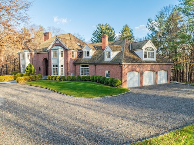 view of front of property with a front yard and a garage